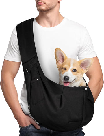 Black adjustable dog sling carrier with a small dog sitting inside